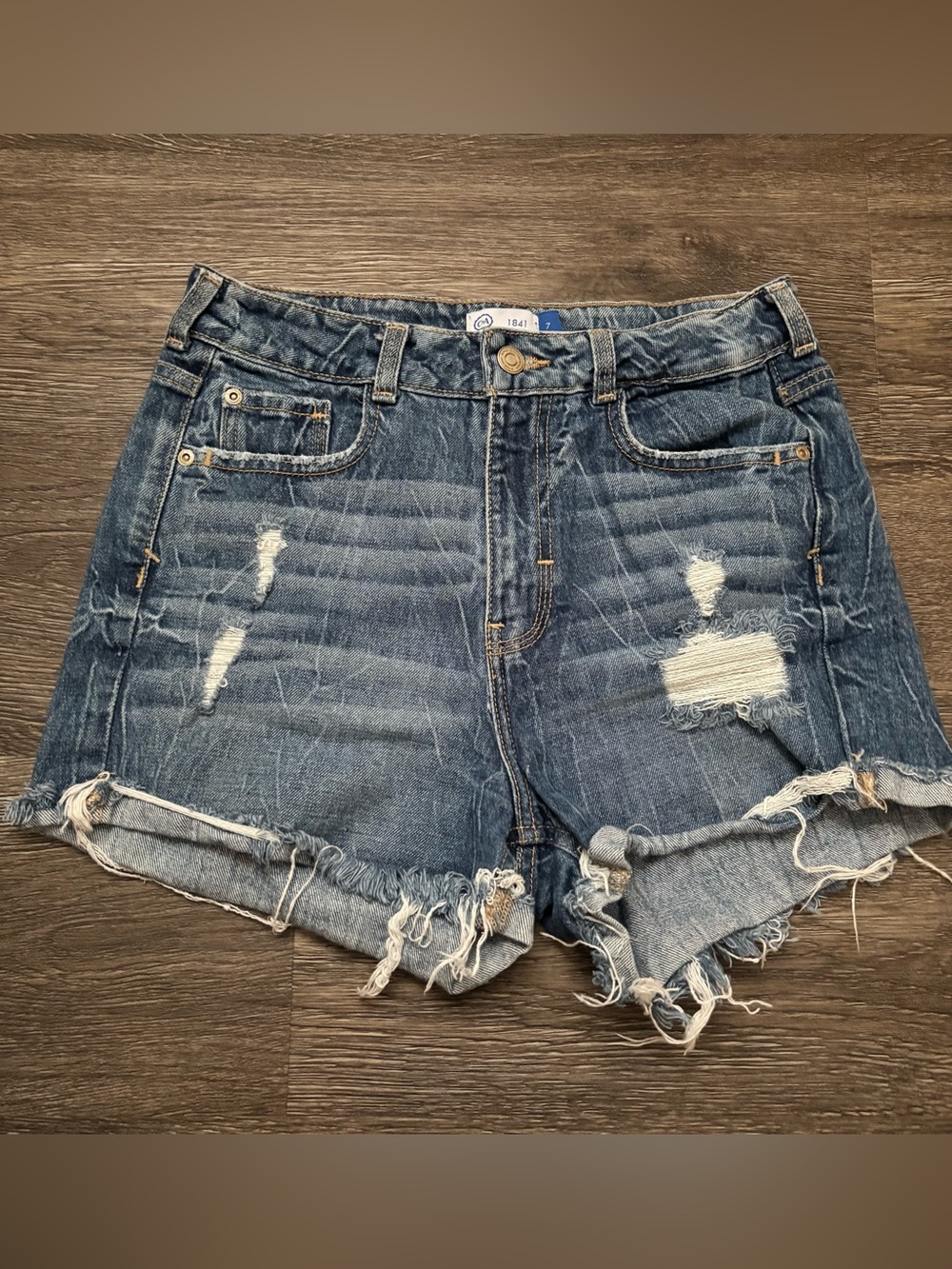 High-Rise Distressed Denim Shorts in Blue